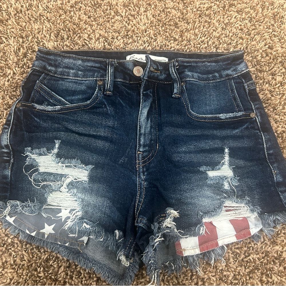 KanCan Distressed Denim Shorts with American Flag pocket peeking out